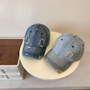 Vintage distressed denim baseball caps in dark and light blue with ripped hole details