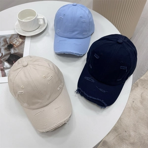 Vintage distressed baseball caps in sky blue, navy, and beige with stylish torn details