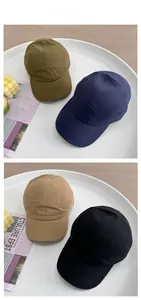 Detail of multi-color minimalist five-panel cotton baseball caps with textured fabric