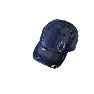 Vintage distressed denim baseball cap in dark blue featuring ripped holes and curved brim