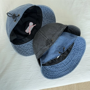 Denim bucket hat with pink bow embroidery and adjustable chin strap in blue and grey