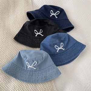 Denim bucket hats with white bow embroidery in four different indigo washes