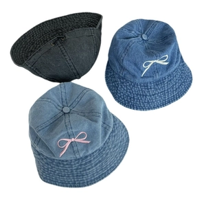 Denim bucket hat with bow embroidery in dark grey, deep blue, and light blue colors
