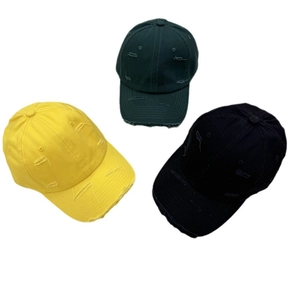 Vintage distressed baseball caps with ripped details in yellow, green, and black