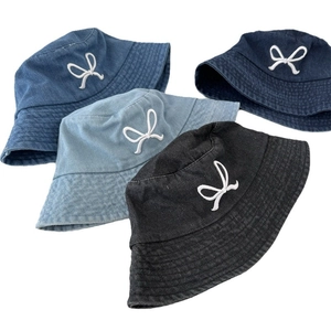 Denim bucket hats with bow embroidery in dark blue, light blue, and black colors