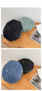 Detail of denim beret hats in black, blue and green with Ofr.Paris heart patch