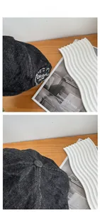 Detail of vintage black denim beret with white Off Paris Est. 1996 embroidery