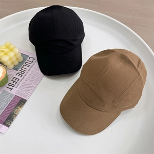 Outdoor Japanese style ripstop baseball caps in black and brown on a white display tray