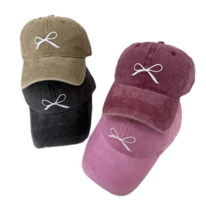 Washed denim baseball caps with embroidered bows in four vintage colors