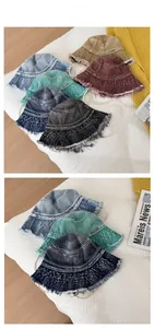 Flat lay display of frayed denim bucket hats in six vintage colors with side woven label