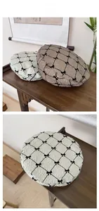 Detail of seersucker beret featuring black bow accents and classic rhombus patterns