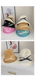 Detailed close-up of breathable hollow-out knit bucket hats with bow jacquard patterns
