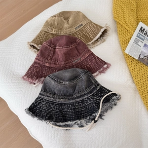 Frayed edge denim bucket hats in khaki, burgundy and black with metal logo detail