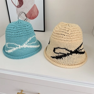 Breathable woven bucket hats in blue and cream with bow pattern for summer sun protection