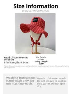 Macro detail of red plaid cotton bucket hat with adjustable windproof drawstring strap