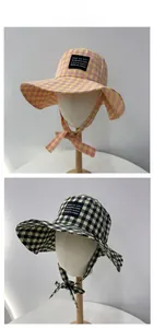 Detail of checkered sun hats with wide brims and adjustable windproof chin straps