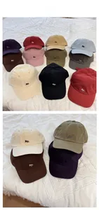 Detail showing various colors of cotton baseball caps with embroidered fox logo