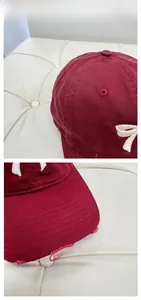 Close-up of distressed wine red baseball cap with My Love 3D embroidery and bow detail