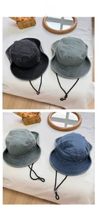 Close-up of vintage washed denim bucket hats with adjustable drawstrings and metal logo