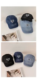 Detailed embroidery of white bow on washed denim baseball caps in three colors