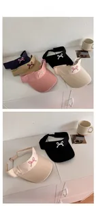 Detailed tile display of sun visors showing embroidery bows and diverse color options