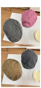 Detailed embroidery view of retro cotton newsboy hats in pink, grey and khaki colors