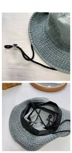 Detail of light blue denim bucket hat with windproof cord and reinforced brim stitching