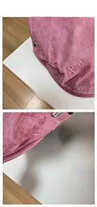 Detail of pink vintage denim newsboy hat featuring washed fabric and XX embroidery