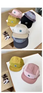 Flat lay of multi-color quick-dry 5-panel caps with retro logo patch in various colors
