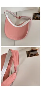 Pink sun visor with adjustable silver buckle and moisture-wicking inner headband