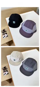 Detail of 5-panel camper hats in four colors with quick-dry fabric and woven labels