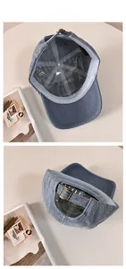Detail view of washed denim baseball cap with adjustable metal buckle and inner lining
