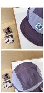 Detail of five-panel outdoor cap showing ripstop fabric texture and logo patch