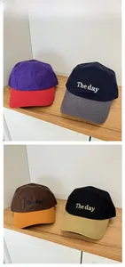 Detailed tile display of four color-blocked camp caps featuring The Day embroidery