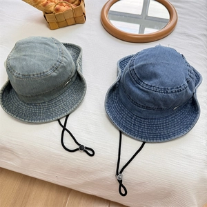 Washed denim bucket hats in light and dark blue with adjustable drawstrings and metal logo