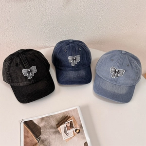 Denim baseball caps with white bow embroidery in black, dark blue and light blue colors