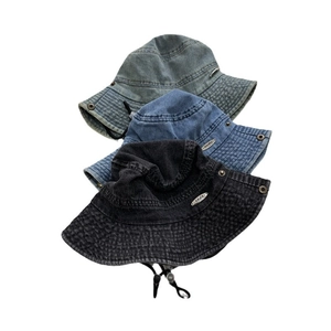 Distressed denim bucket hat with metal brand plate and adjustable windproof strap in three colors