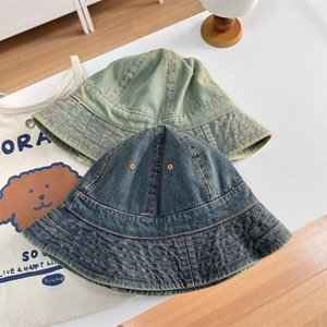 Retro denim bucket hats in dark blue and washed yellow-green with heavy stitching