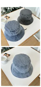 Close-up of BDMYFF letter embroidery on washed denim bucket hats in black and light blue