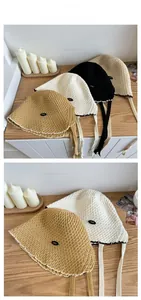 Close-up of four colors breathable hollow-out straw sun hats with stylish tie straps