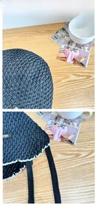 Detail of dark blue crochet sun hat featuring white contrast stitching and woven ties
