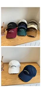 Detail showing vintage distressed edges and monoomi embroidery on washed cotton baseball caps