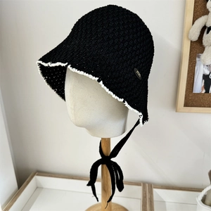 Women's black crochet straw bucket hat with white lace trim and adjustable chin strap