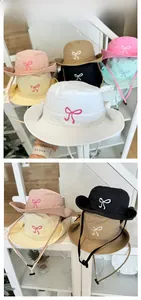 Detail of colorful sun hats with bow embroidery and adjustable windproof straps