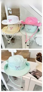 Detail of lightweight quick-dry sun hats with bow embroidery in four pastel colors