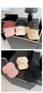 Detail of distressed short brim baseball cap with frayed edges and safety pin embroidery