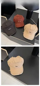 Detail showing distressed raw edges and pin embroidery on short-brim canvas baseball cap