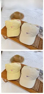 Detail of embroidered heart and letter patterns on casual cotton ponytail sun hats