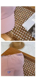 Detail of pink cotton baseball cap featuring purple heart and letter embroidery