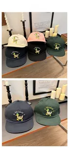 Detail showing colorful duck embroidery and vintage drawstrings on cotton baseball caps